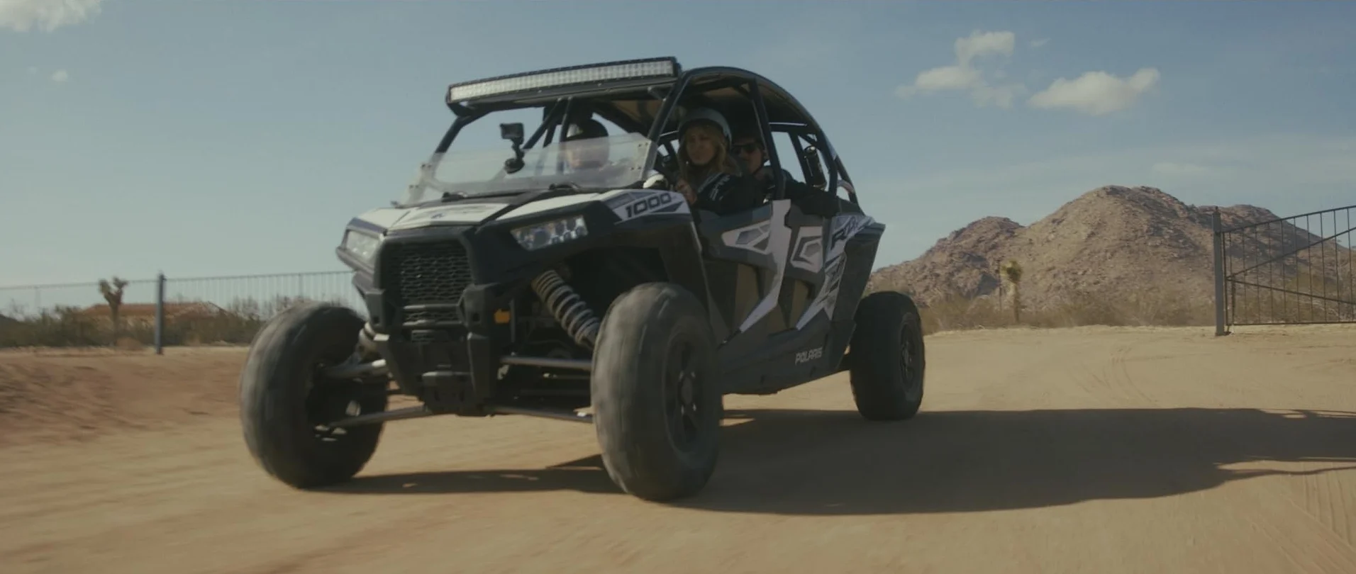 Off-road vehicle driving through a desert landscape